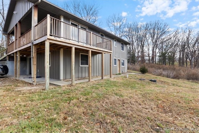 back of house with a yard and a wooden deck