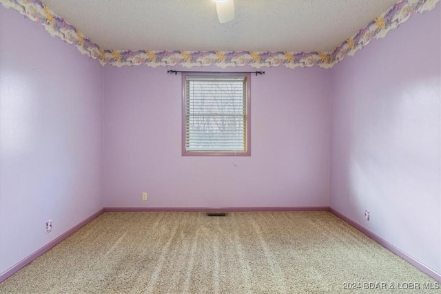 carpeted spare room featuring a textured ceiling