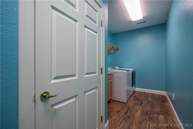 825 Grand View Dr, Porto Cima, MO 65079 - laundry room featuring washing machine and dryer and dark wood-type flooring