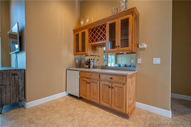 825 Grand View Dr, Porto Cima, MO 65079 - bar area with dishwasher and light tile patterned floors