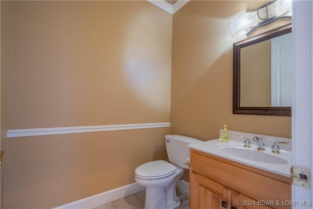 bathroom featuring tile patterned flooring, vanity, ornamental molding, and toilet