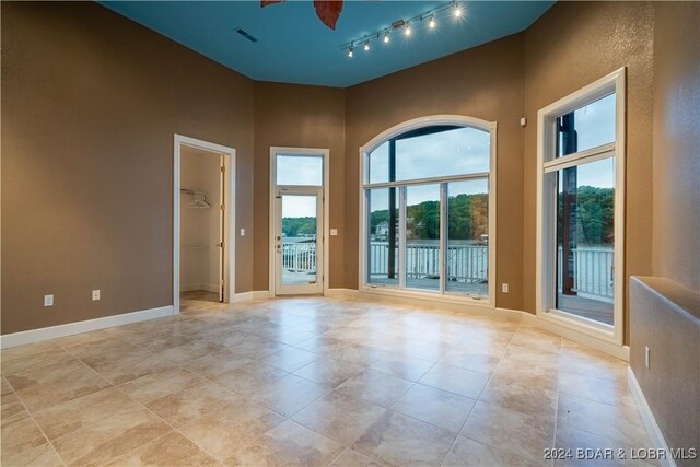 825 Grand View Dr, Porto Cima, MO 65079 - unfurnished room with light tile patterned floors and track lighting