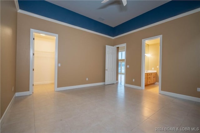 tiled spare room with ceiling fan and ornamental molding