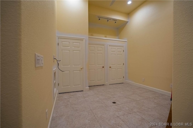 hall featuring light tile patterned floors