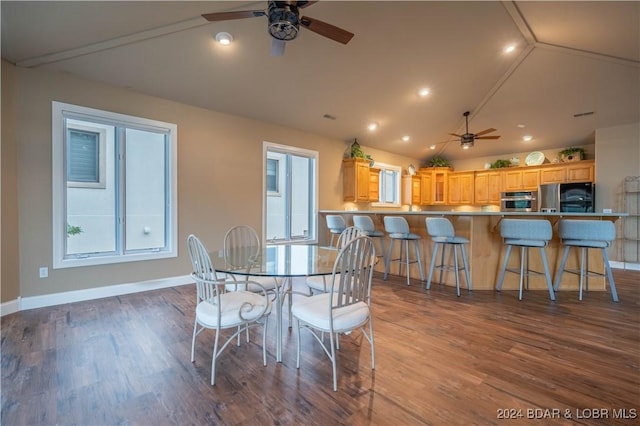 dining area with ceiling fan, lofted ceiling, and hardwood / wood-style flooring