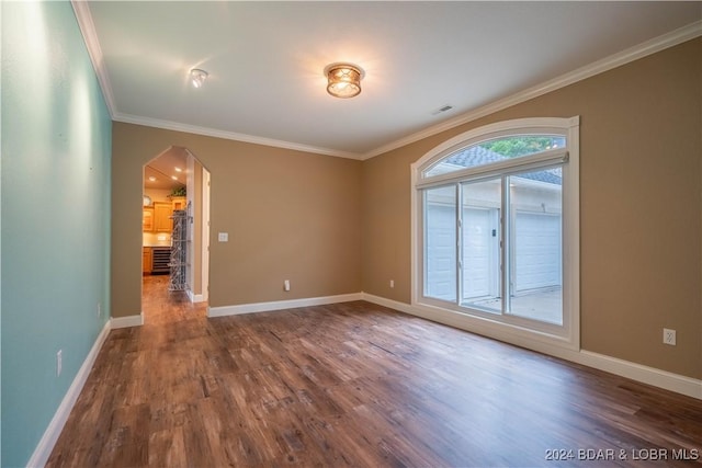 unfurnished room featuring wood-type flooring and ornamental molding