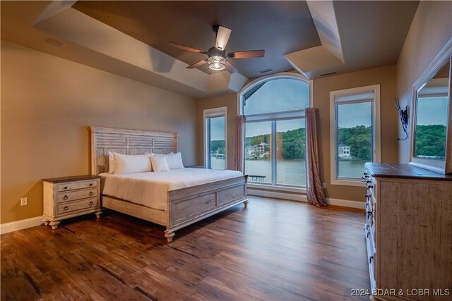 825 Grand View Dr, Porto Cima, MO 65079 - bedroom with dark wood-type flooring, a raised ceiling, and ceiling fan