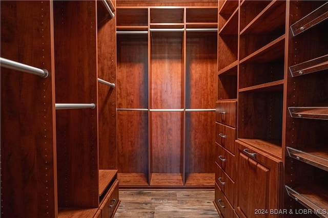 walk in closet featuring hardwood / wood-style floors