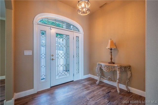 foyer featuring an inviting chandelier and dark wood-type flooring