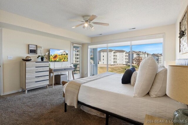 carpeted bedroom featuring ceiling fan and a textured ceiling