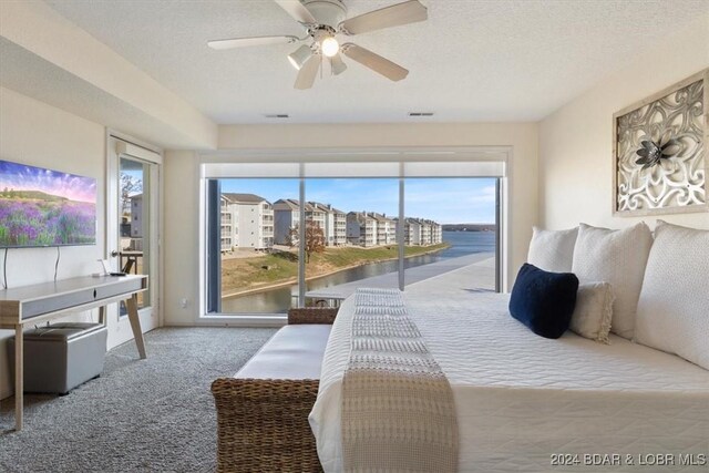 bedroom with carpet, ceiling fan, access to exterior, and multiple windows