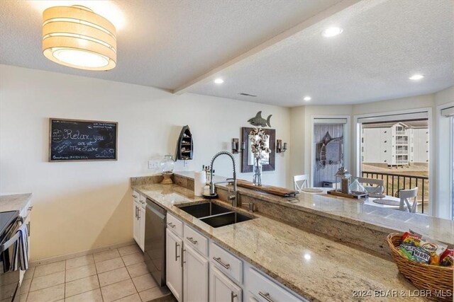 kitchen with light stone countertops, stainless steel dishwasher, a textured ceiling, sink, and range