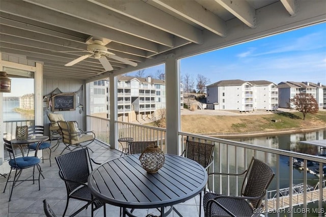 balcony featuring ceiling fan and a water view