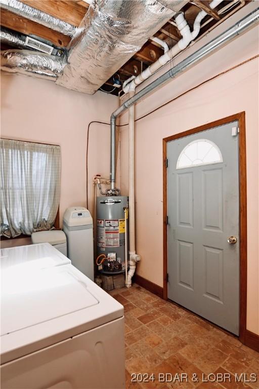 26 Gap Rd, Tunas, MO 65764 - laundry room with gas water heater, washing machine and clothes dryer, baseboards, and stone finish flooring