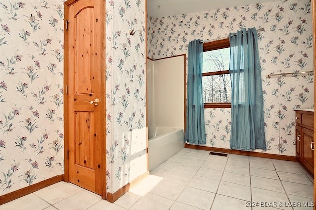 bathroom featuring a tub, tile patterned flooring, and vanity