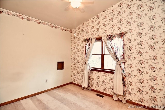 spare room featuring carpet flooring and ceiling fan