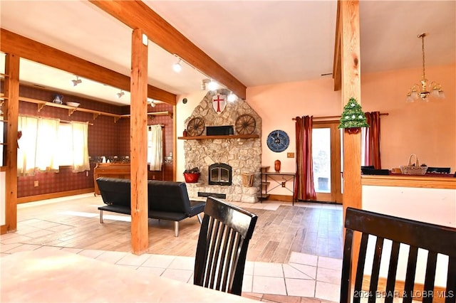 kitchen with a fireplace, plenty of natural light, beamed ceiling, and light wood-type flooring