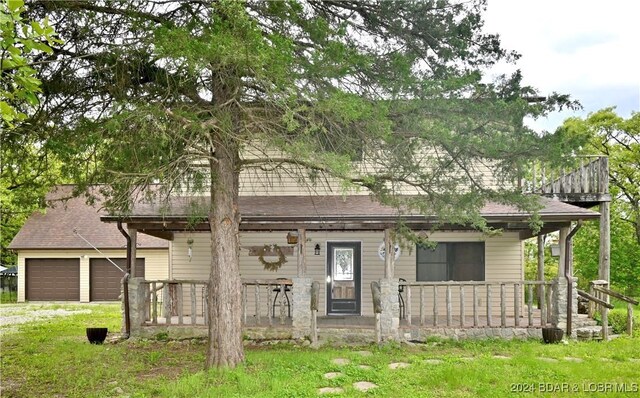 26 Gap Rd, Tunas, MO 65764 - view of front of house with a porch, driveway, a garage, a front lawn, and a shingled roof