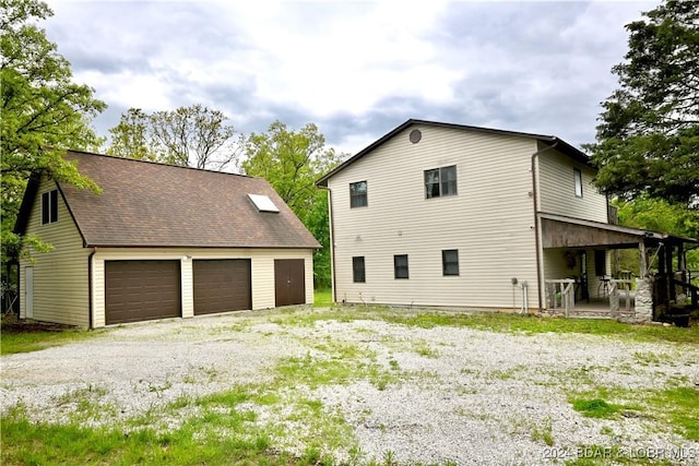 26 Gap Rd, Tunas, MO 65764 - view of side of home with an outbuilding and a detached garage