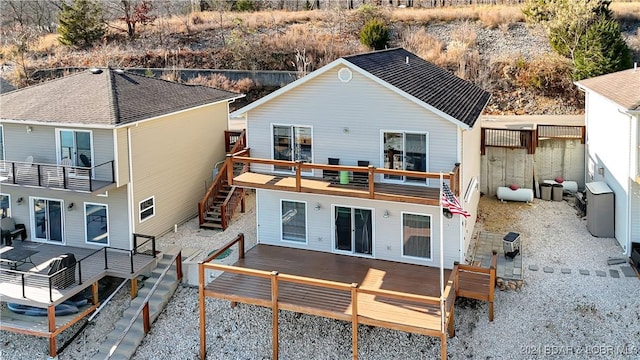 back of house with a balcony and a deck