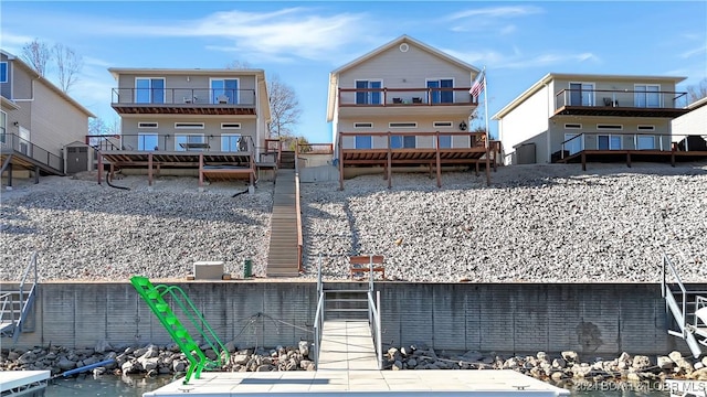 rear view of house featuring a water view