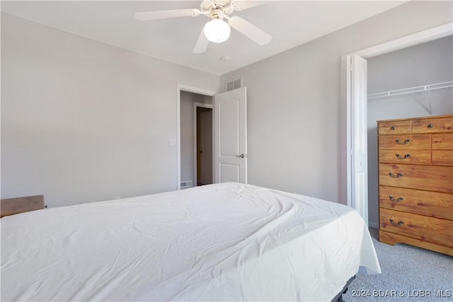 carpeted bedroom with a closet and ceiling fan