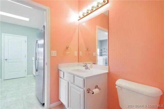 bathroom with tile patterned floors, vanity, and toilet