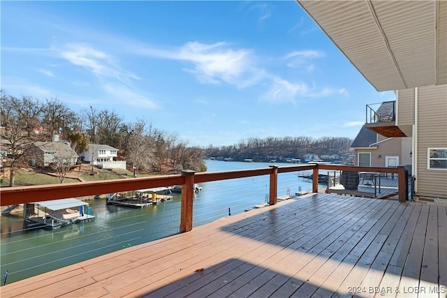 wooden terrace featuring a water view