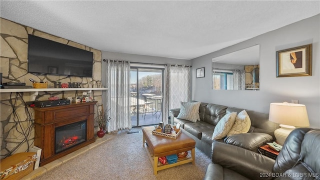 carpeted living room featuring a fireplace and a textured ceiling