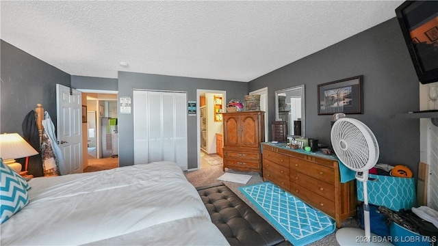 carpeted bedroom with connected bathroom, a closet, and a textured ceiling