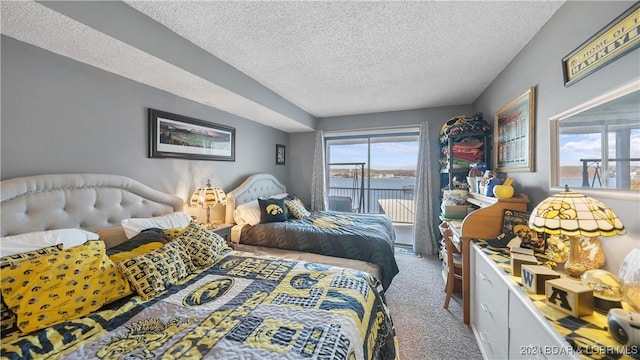 carpeted bedroom with access to outside, a textured ceiling, and a water view