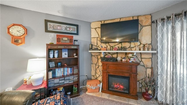 living area featuring carpet flooring, a fireplace, and a textured ceiling