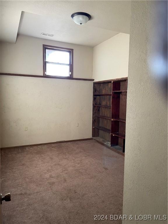 unfurnished room featuring carpet floors