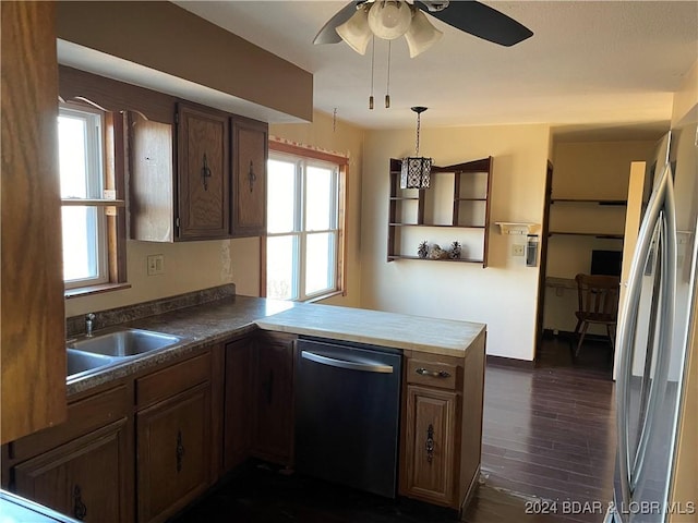 kitchen with ceiling fan, sink, stainless steel appliances, dark hardwood / wood-style flooring, and kitchen peninsula