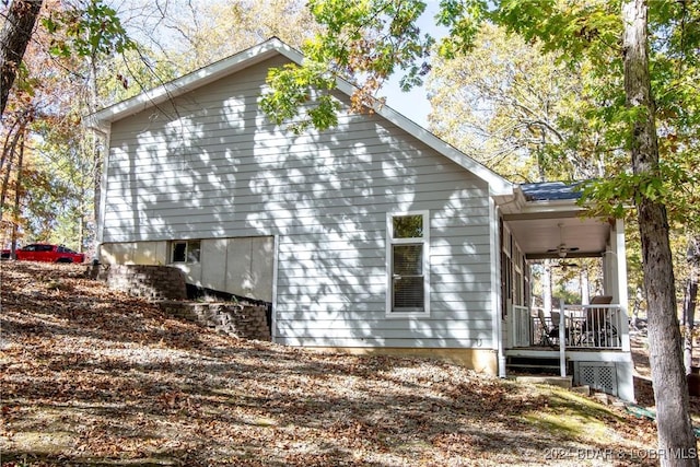 view of side of property with ceiling fan and covered porch