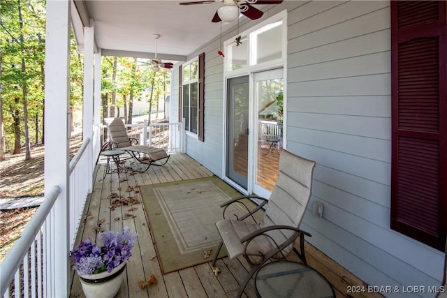 wooden deck with ceiling fan and a porch