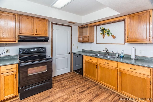 kitchen featuring sink, backsplash, dark wood-type flooring, and black appliances