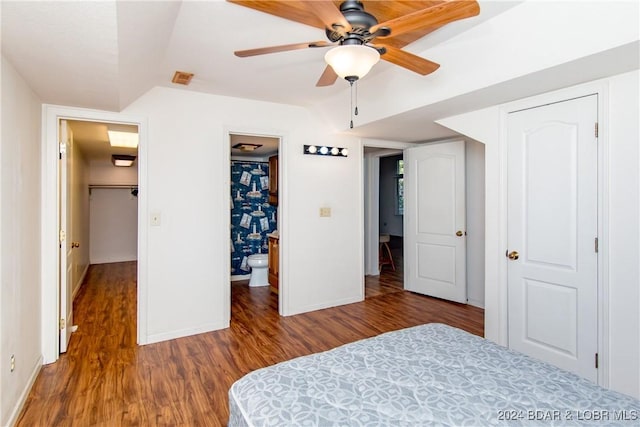 unfurnished bedroom with ceiling fan, ensuite bath, wood-type flooring, and a closet