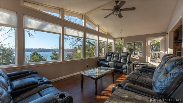 sunroom / solarium featuring ceiling fan, a water view, and lofted ceiling