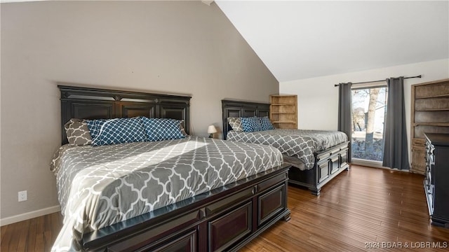 bedroom featuring high vaulted ceiling and dark hardwood / wood-style floors