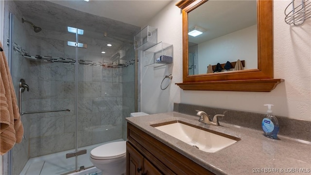 bathroom with vanity, toilet, and walk in shower