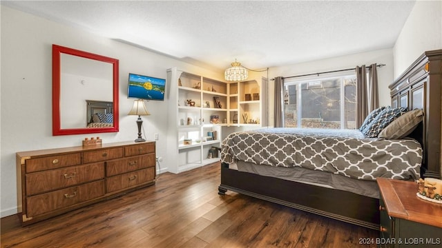 bedroom featuring a textured ceiling and dark wood-type flooring