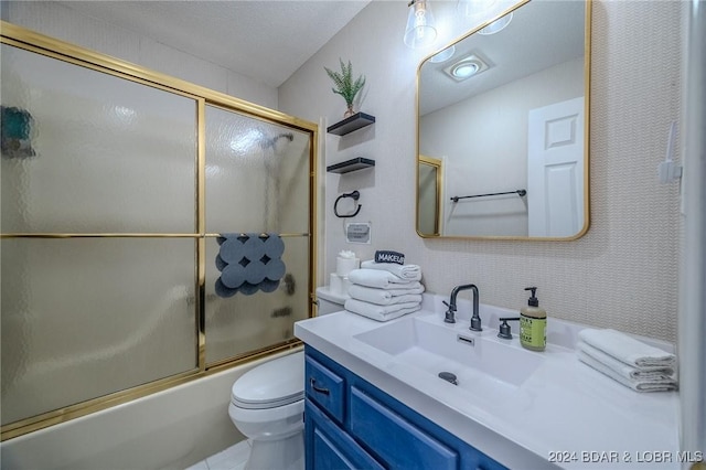 full bathroom with vanity, toilet, shower / bath combination with glass door, and a textured ceiling