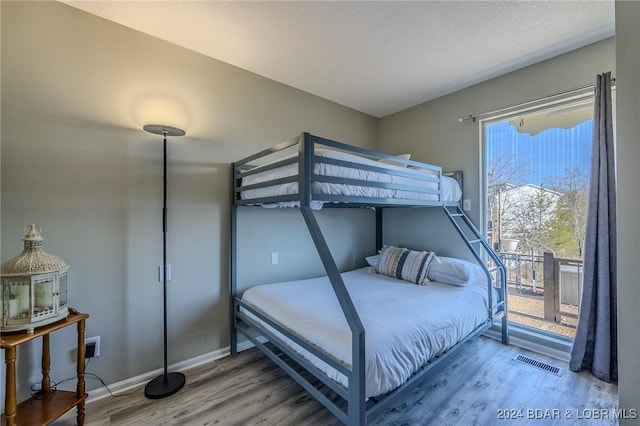 bedroom with hardwood / wood-style flooring