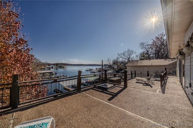 exterior space with a patio area and a water view