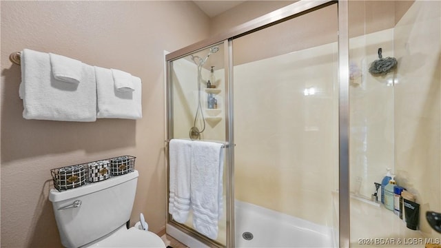 bathroom featuring toilet and walk in shower