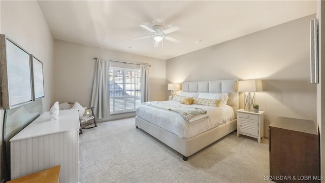 bedroom featuring light carpet and ceiling fan