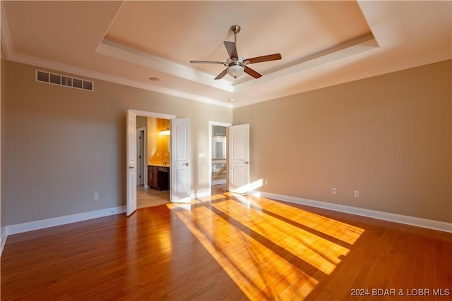 550 Grand Cove Rd, Porto Cima, MO 65079 - spare room with a tray ceiling, a ceiling fan, crown molding, wood finished floors, and baseboards