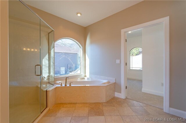 bathroom with tile patterned flooring and independent shower and bath