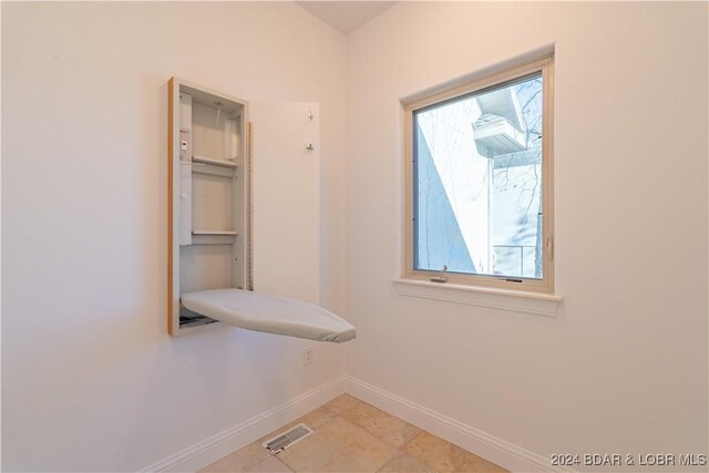 interior space with light tile patterned floors and a wealth of natural light